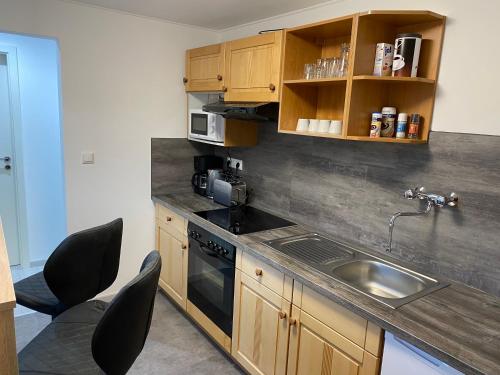 a kitchen with a sink and a counter top at Ferienwohnung H&M Immobilien Hettstedt in Hettstedt