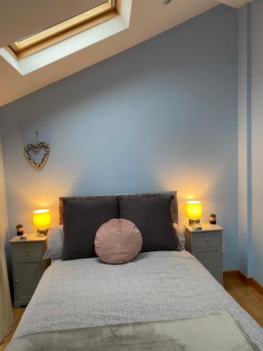 a bedroom with a large bed with two lamps on it at The little crab hut in Sheringham