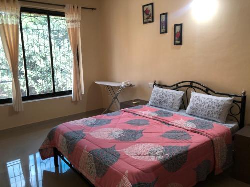 a bedroom with a bed and two pillows on it at Field stone Apartment in Varca