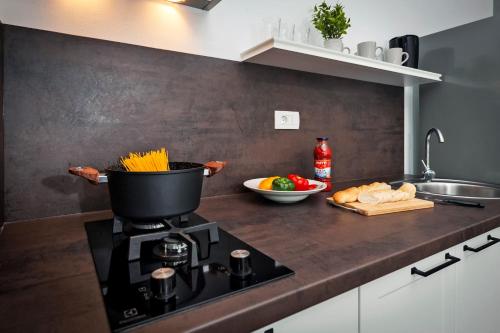 a kitchen with a stove with a pot on it at Deluxe Apartments A&A in Rovinj