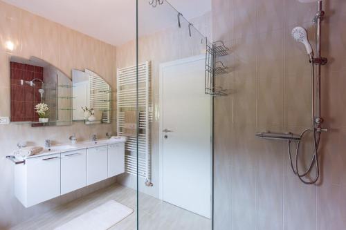a bathroom with a glass shower and a sink at Villa Lavandula in Tribalj