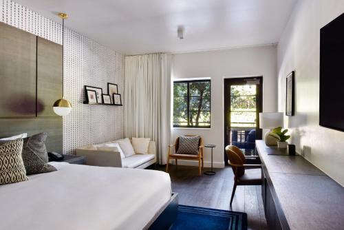 a bedroom with a bed and a living room at Kaskades Hotel South Beach in Miami Beach