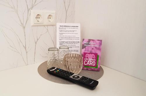 a remote control sitting on a table next to a bag of candy at Dat lütte Heidehotel Funk - Garni in Bispingen