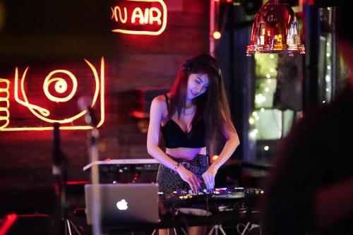 a woman playing drums on a table with a laptop at Letana Hotel in Bang Phli