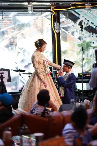 a bride and groom feeding each other on a stage at Letana Hotel in Bang Phli