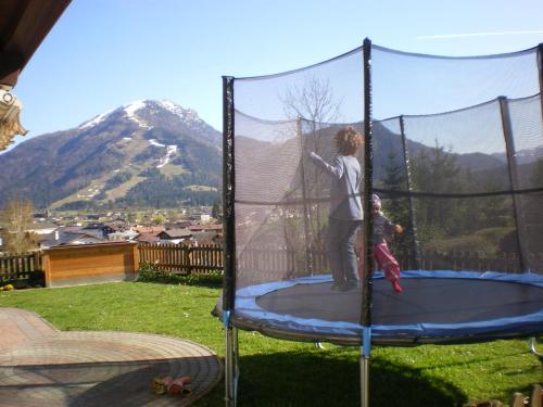 a young child playing on a trampoline at Haus Sonnleit in Kössen