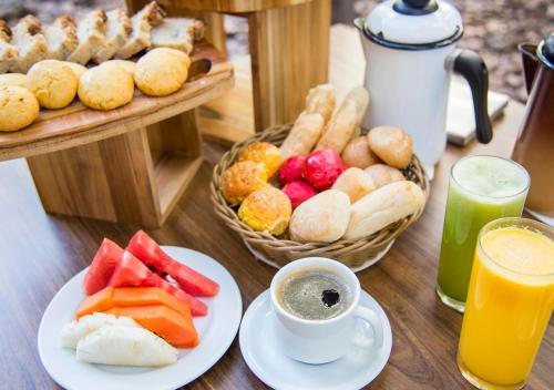 a table topped with plates of food and drinks at Estanplaza Paulista in Sao Paulo