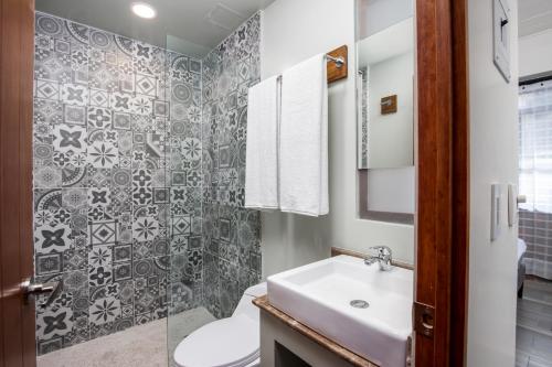 a bathroom with a sink and a toilet at Joint Coworking Hotel in Puerto Vallarta