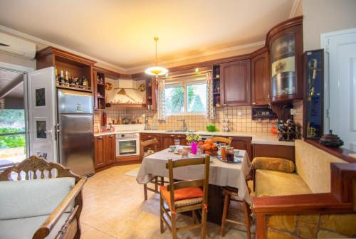 a kitchen with a table and a dining room at Loukas Farm House in Ayios Kirikos