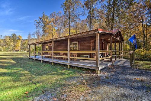 a wooden cabin in the middle of a field at Cozy Anchors Away Cabin Hideaway with Fire Pit! in Parsons