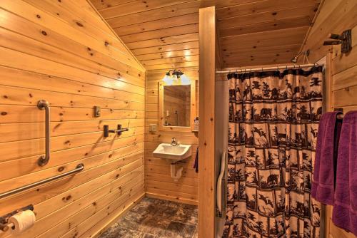 a wooden bathroom with a sink and a mirror at Cozy Anchors Away Cabin Hideaway with Fire Pit! in Parsons