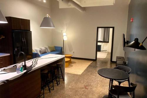 a kitchen and living room with a couch and a table at 3E-*New* Apt 10 min to Children’s Hospital, slps 4 in Pittsburgh