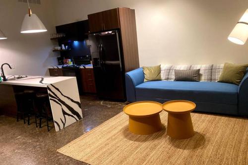 a living room with a blue couch and two stools at 3E-*New* Apt 10 min to Children’s Hospital, slps 4 in Pittsburgh