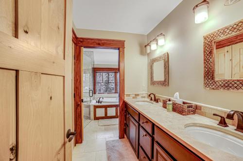 a bathroom with two sinks and a large mirror at Around the Mountains in Chestertown