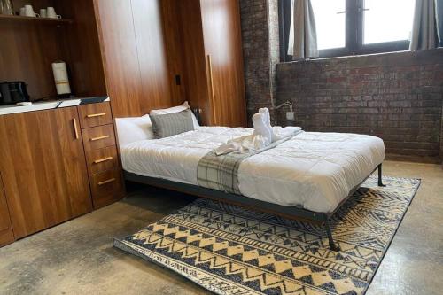 a bedroom with a bed and a dresser at 3E-Cozy! Micro apartment minutes from Shadyside, sleeps 1 in Pittsburgh