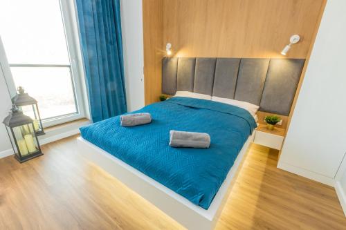 Säng eller sängar i ett rum på Royal Manu Apartment NETFLIX