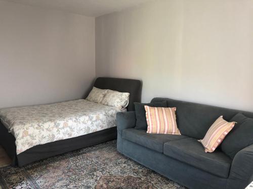 a living room with a couch and a bed at Villa Victoria in Rydzewo