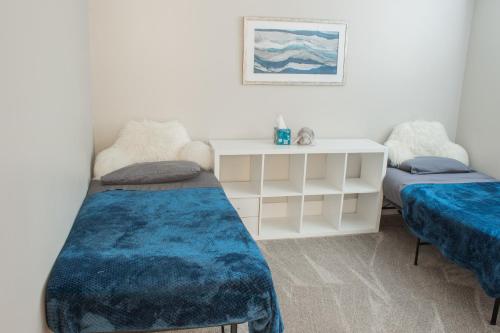 a room with two beds and a table at Family Friendly Home - Utah Valley Sanctuary in Orem