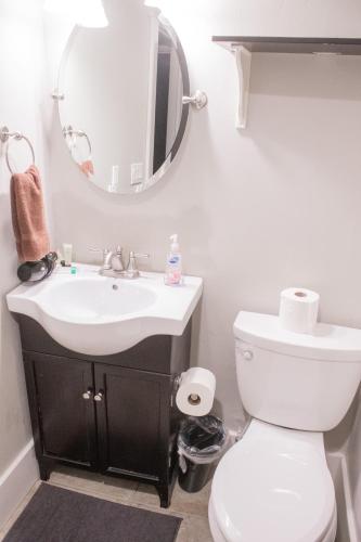 a bathroom with a sink and a toilet and a mirror at Family Friendly Home - Utah Valley Sanctuary in Orem