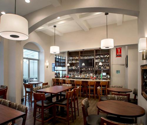 a restaurant with tables and chairs and a bar at Holiday Inn Manhattan 6th Ave - Chelsea by IHG in New York