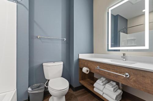 a bathroom with a toilet and a sink and a mirror at Extended Stay America Premier Suites - Orlando - Sanford in Sanford