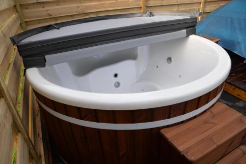 a bath tub sitting inside of a building at Le Breil Furet in Ménéac