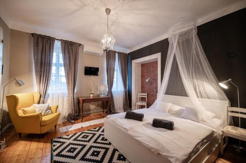 a bedroom with a white bed with a canopy at Boutique B&B Mali Pariz in Crikvenica