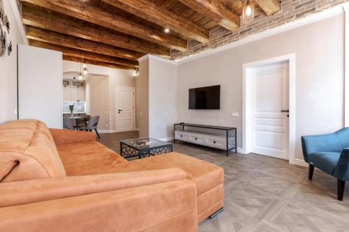 ein Wohnzimmer mit einem Sofa und einem TV in der Unterkunft View on Rynok Square apartments in Lwiw
