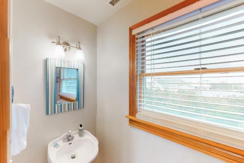a bathroom with a sink and a window at Shenanigans #57-2 in Avon