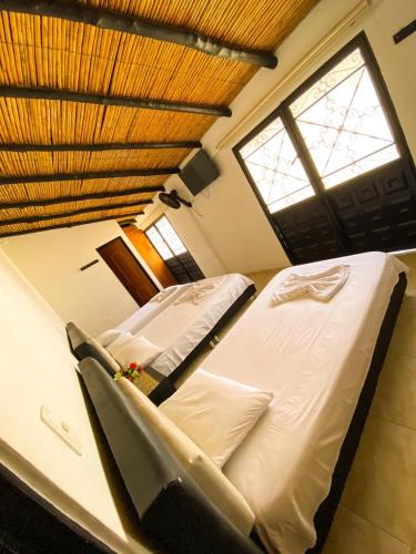a bedroom with a large bed and a window at Hotel Mirador de Santa Bárbara in Socorro