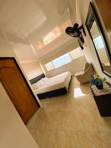 an attic room with a bed and a window at Hotel Mirador de Santa Bárbara in Socorro