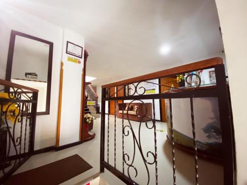a room with a staircase with a mirror and a door at Hotel Mirador de Santa Bárbara in Socorro