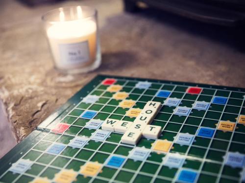 a chess board and a candle on a table at West House in Middleton in Teesdale
