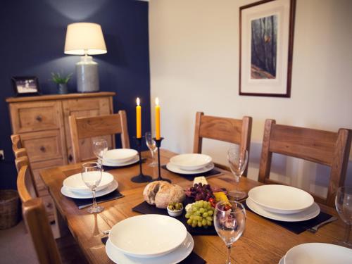 a dining room table with plates and wine glasses at West House in Middleton in Teesdale