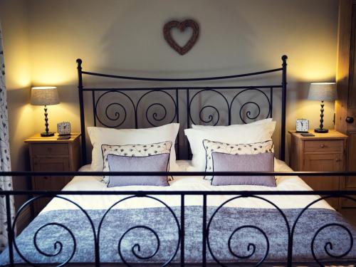 a bedroom with a bed with a heart on the wall at West House in Middleton in Teesdale