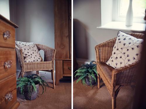 a wicker chair with a pillow sitting next to a dresser at West House in Middleton in Teesdale