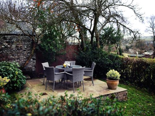 a table and chairs on a patio in a garden at West House in Middleton in Teesdale