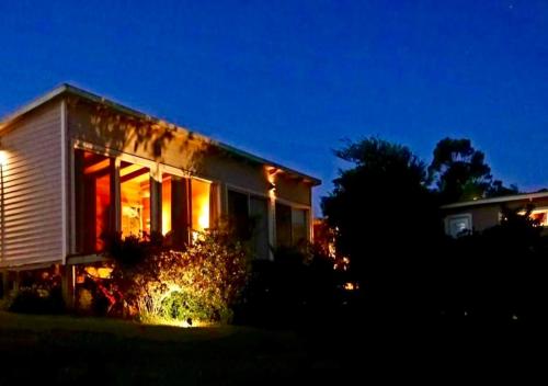 a house at night with lights in the window at Hjem Studios in La Pedrera