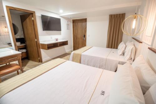 Cama o camas de una habitación en Six Hotel Guadalajara Degollado