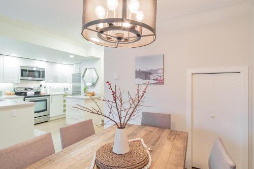 a dining room with a table with a vase on it at Sunpath by Outpost Whistler in Whistler