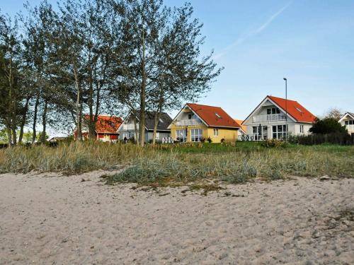 a group of houses sitting on the beach at 8 person holiday home in Gelting in Gelting