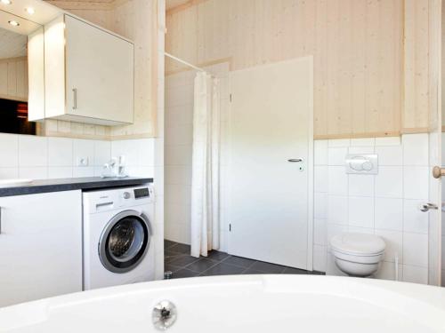 a bathroom with a washing machine and a toilet at Three-Bedroom Holiday home in Großenbrode 8 in Großenbrode