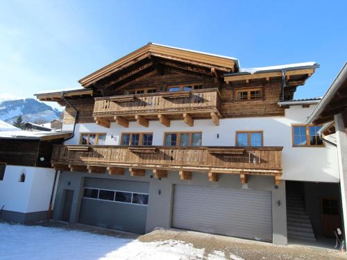 a house with a balcony and a garage at Apartment in Kaprun with Ski-in Ski-out Access in Kaprun