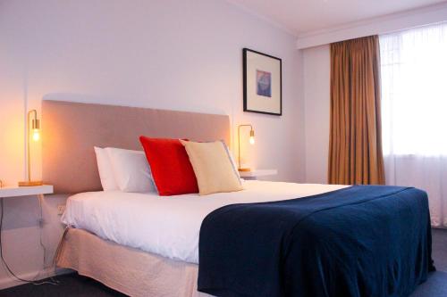 A bed or beds in a room at The Clan Terrigal