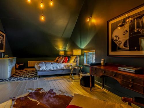 a bedroom with a bed and a table in a room at Luxurious holiday home in Heers with terrace in Mettekoven