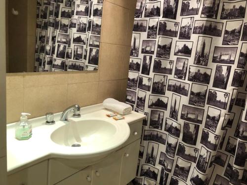 a bathroom with a sink and a mirror and a shower curtain at Concord Pilar Suite Almendros in Pilar