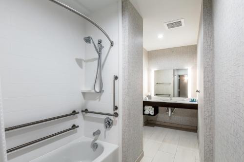 a bathroom with a shower and a sink at Holiday Inn Express & Suites Jersey City North - Hoboken, an IHG Hotel in Jersey City