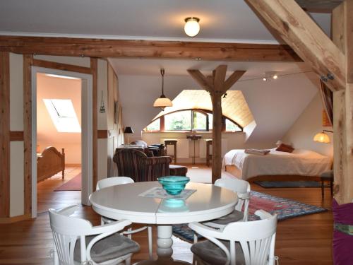 a room with a table and chairs and a bedroom at Buschenhagen Rustic Getaway in Buschenhagen