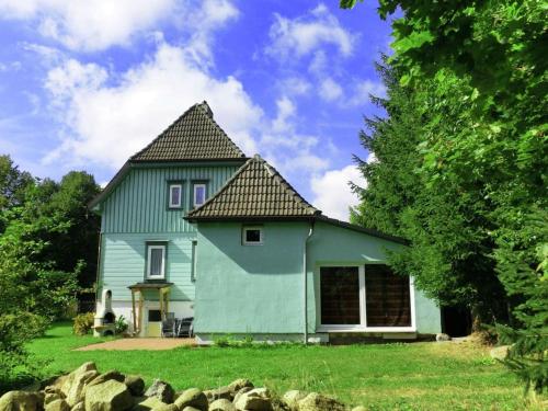 a blue house with a black roof at Luxury holiday home in Elend with private pool in Elend
