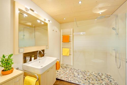 a bathroom with a sink and a shower at Ferienhaus Kessler in Riezlern